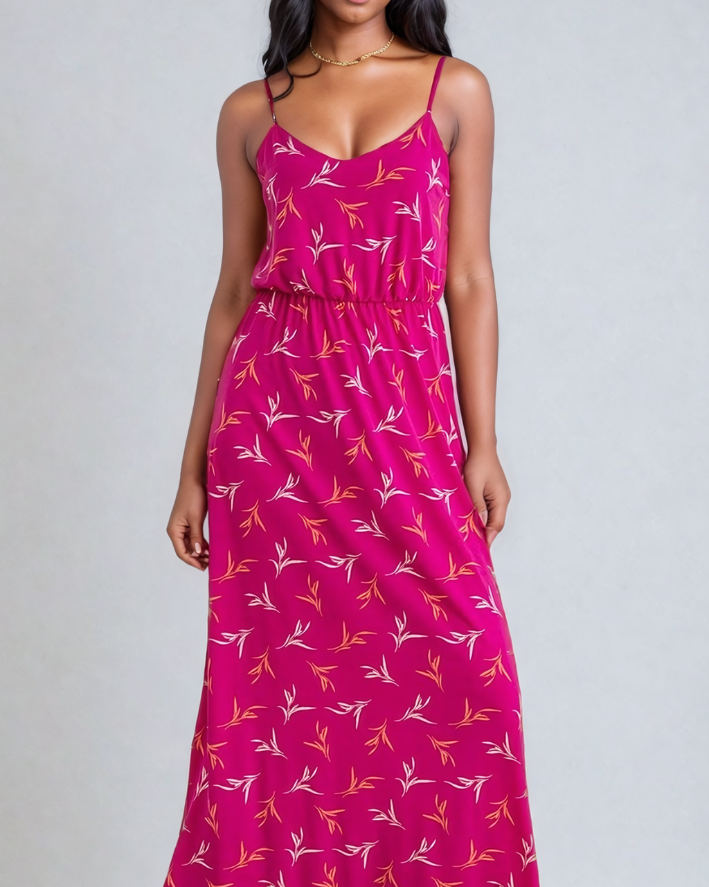 Image of a woman wearing a Fly Away Cami Maxi Dress in a vibrant floral print, suitable for various occasions, with adjustable straps and a flattering cami neckline.