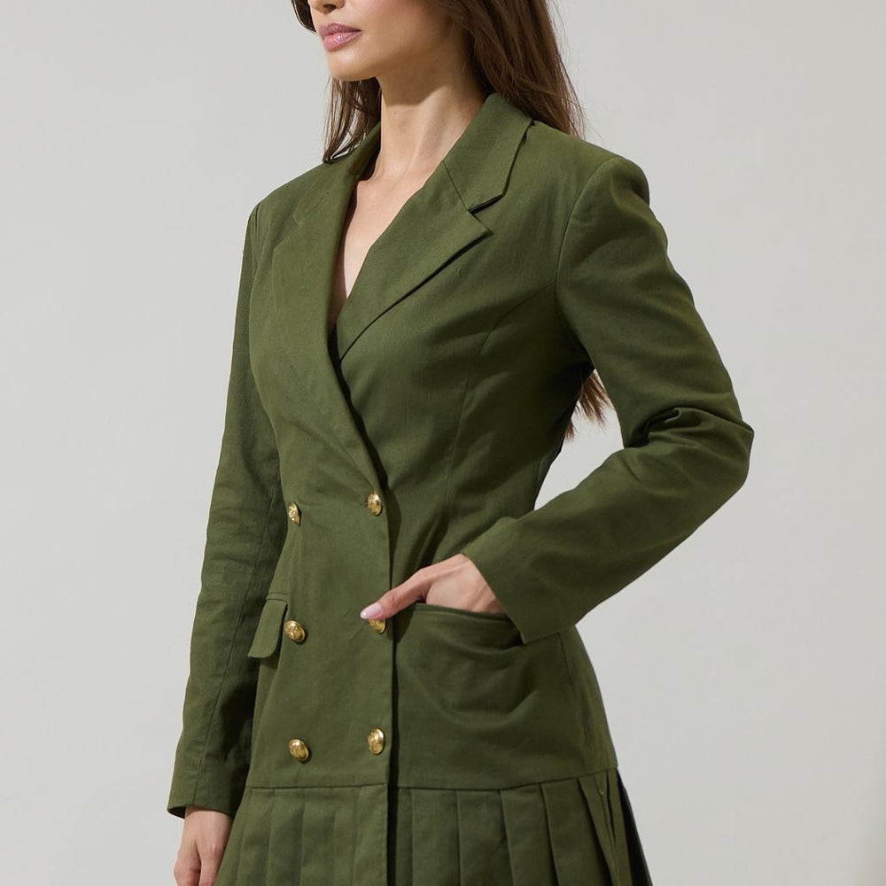 
                      
                        Woman wearing a green blazer dress against a plain background


                      
                    